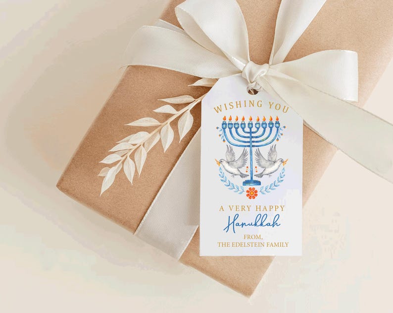 May include: A gift box wrapped in brown paper with a white ribbon and a decorative tag. The tag features a blue menorah, doves, and the text "Wishing You A Very Happy Hanukkah".