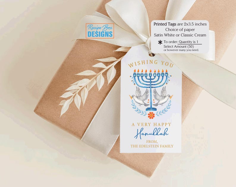 May include: A Hanukkah gift tag with a blue menorah, doves, and the text "Wishing You A Very Happy Hanukkah." The tag is tied to a wrapped gift with a white ribbon. The tag measures 2 x 3.5 inches.
