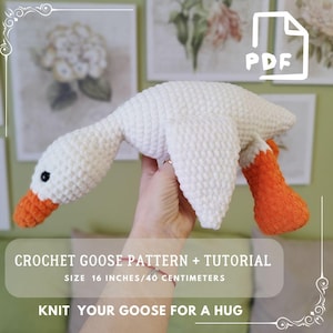 May include: A handmade white crochet goose with orange beak and feet. The goose is approximately 16 inches in length. The image includes the text "CROCHET GOOSE PATTERN + TUTORIAL" and "KNIT YOUR GOOSE FOR A HUG".