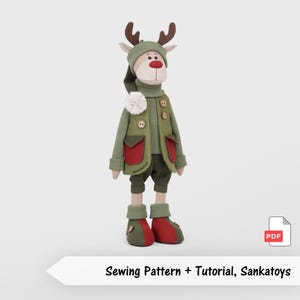 May include: A fabric reindeer doll wearing a green ribbed sweater, a green vest with red pockets, dark green shorts, and red and green shoes. The doll has brown antlers, a red nose, and a white pom-pom on the vest. Includes a PDF sewing pattern.