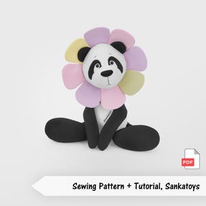 May include: A plush panda toy with a white face, black eye patches, and black ears, surrounded by a colorful flower-shaped collar in pastel yellow, pink, and lavender. The body is black and white with the text @sankatoys and Sewing Pattern + Tutorial, Sankatoys.