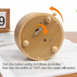 May include: A wooden music box with a spring mechanism on the bottom. Turn the spring clockwise 2-3 times, then turn the switch to "ON" to play music.