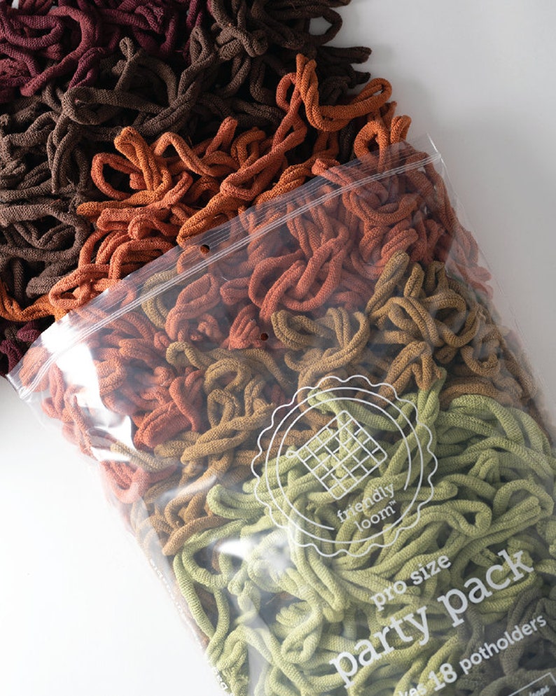 May include: A clear plastic bag filled with a variety of colors of yarn for crocheting. The yarn is in shades of brown, orange, yellow, and green. The bag has a label that says "friendly loom" and "pro size party pack".
