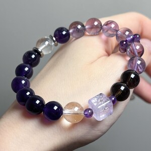 Side view of a natural amethyst bracelet worn on the wrist, showing fit and luster.