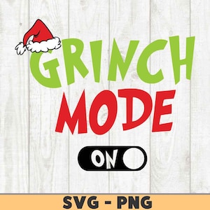 以下が含まれることがあります： 緑と赤のグラフィックテキストで「Grinch Mode On」と書いてあり、赤いサンタの帽子と白黒のトグルスイッチが付いています。