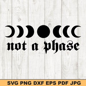 May include: Black graphic design featuring phases of the moon and the text "not a phase" in a gothic font. The design is set against a light wood grain background. The bottom of the image includes file type information.