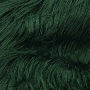 May include: A close-up of a deep green faux fur fabric. The fur is soft and fluffy, with a subtle sheen.