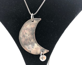 Crescent moon necklace made from salvaged copper from restorations on historic buildings in Sackets Harbor, NY. Natural and worn patina