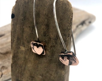 Recycled copper and silver raised heart dangle earrings. Hammered and oxidized detail. Handmade