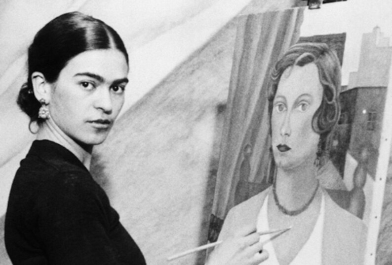 May include: A black and white photo of a woman painting a portrait of another woman. The woman painting is holding a paintbrush in her right hand and is looking at the camera. The woman in the portrait is looking straight ahead. The portrait is of a woman with dark hair and a necklace.