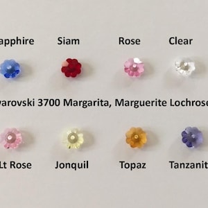 May include: Assortment of Swarovski 3700 Margarita, Marguerite Lochrose crystals in various colors, including sapphire, siam, rose, clear, light rose, jonquil, topaz, and tanzanite.