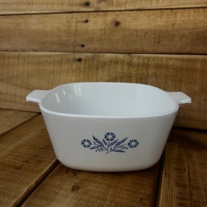 May include: White square baking dish with blue floral design.