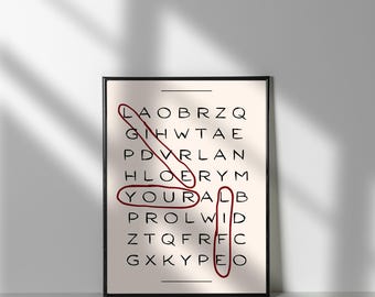 Puede incluir: Una impresión enmarcada con fondo blanco y marco negro. La impresión presenta un crucigrama con la palabra "YOUR ALL" encerrada en rojo.