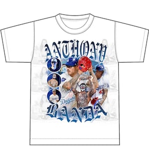 May include: White t-shirt with a graphic print of baseball players and the text "Anthony Banda".