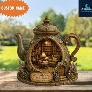 May include: A decorative teapot-shaped diorama featuring a detailed interior library scene with a green armchair, a lamp, and bookshelves. The exterior is sage green with floral accents and a plaque reading Emily's Tea & Stories Est. 2026.