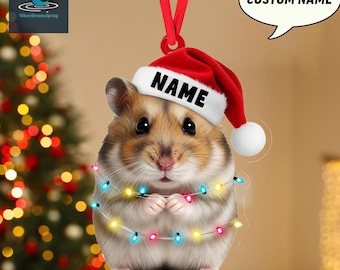 May include: A Christmas ornament featuring a hamster wearing a Santa hat with the word "NAME" on it. The hamster is adorned with a string of colorful lights. A speech bubble says "CUSTOM NAME" and the text "2D FLAT ITEM" is at the bottom.
