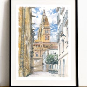 May include: Watercolor painting of a narrow street in a European city. The street is lined with tall buildings, and a church tower rises above the buildings in the background. The sky is blue with white clouds.