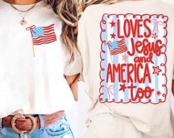 May include: Ivory-colored t-shirt featuring an American flag graphic on the front and the phrase "LOVES Jesus and AMERICA too" on the back. The design includes red, white, and blue elements, stars, and stripes, perfect for patriotic wear.
