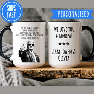 May include: White ceramic mug with a black handle. The mug has a black and white image of a man with a thumbs up gesture and text that reads "You are a great grandpa. Really, really great! Very special, just fantastic. Other grandpas? Losers! Total disasters. Everyone agrees. Believe me." The other side of the mug has black text that reads "We love you grandpa!" with three stars below. The text "Liam, Owen & Olivia" is below the stars.