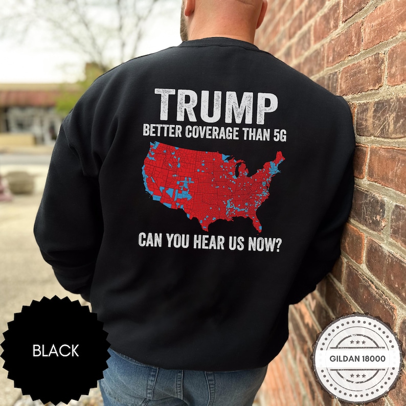 May include: Black sweatshirt with a white graphic of a map of the United States with red and blue markings. The text "TRUMP BETTER COVERAGE THAN 5G CAN YOU HEAR US NOW?" is printed on the sweatshirt.