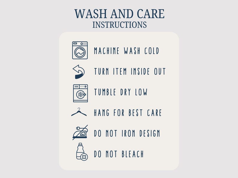May include: Cream-colored card with navy blue text and icons detailing wash and care instructions. The instructions include machine wash cold, turn item inside out, tumble dry low, hang for best care, do not iron design, and do not bleach.