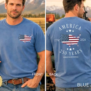 May include: Blue jean-colored t-shirt with a distressed American flag design in the shape of the United States. The front features a small flag graphic, while the back displays "AMERICA" and "250 YEARS" with the years 1776 and 2026.