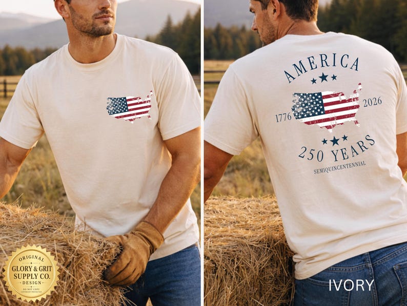 May include: Ivory-colored t-shirt featuring a distressed American flag design on the front pocket and back. The back design includes the text "AMERICA 250 YEARS SEMIQUINCENTENNIAL 1776-2026". The shirt is made of a soft material.