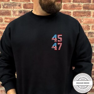 May include: Black sweatshirt with the numbers 45 and 47 printed in red, white, and blue, resembling the American flag.