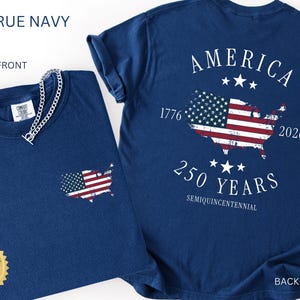 May include: Two navy blue t-shirts. One shows the front with a small American flag graphic on the pocket. The other shows the back with a large American flag graphic in the shape of the USA, with the text "AMERICA 250 YEARS".