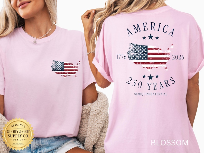 May include: A light pink t-shirt with a distressed American flag design in the shape of the United States on the front and back. The back of the shirt also features the text "AMERICA 250 YEARS 1776-2026 SEMIQUINCENTENNIAL".