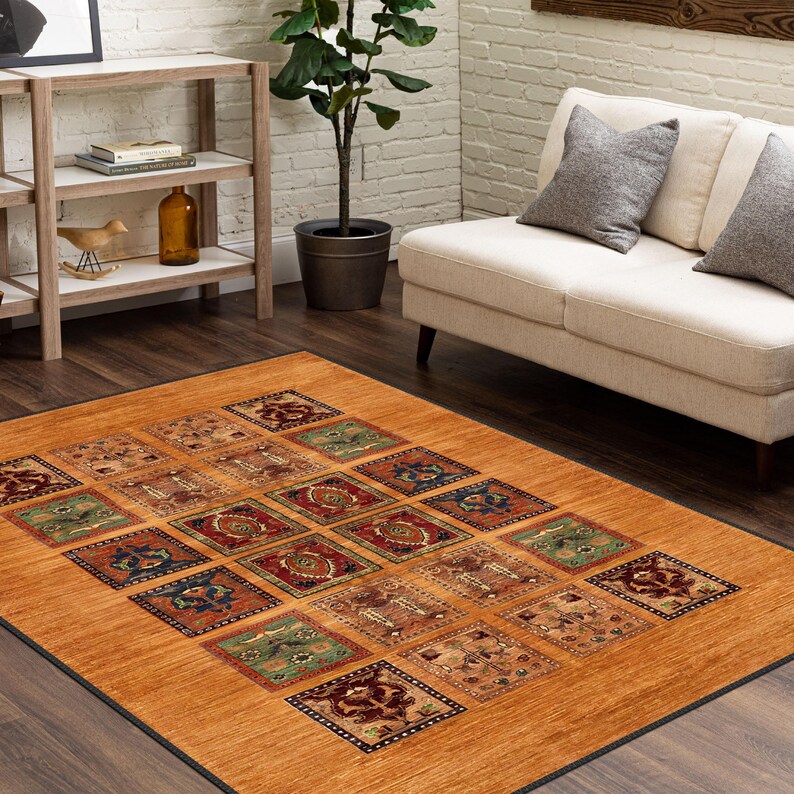 May include: A patterned area rug with a brown background and a geometric design in shades of red, blue, green, and beige. The rug is laid out on a hardwood floor in a living room setting.