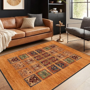 May include: A brown area rug with a geometric pattern of squares in various colors, including red, blue, green, and gold. The rug has a black border and is laid out on a hardwood floor in a living room setting.