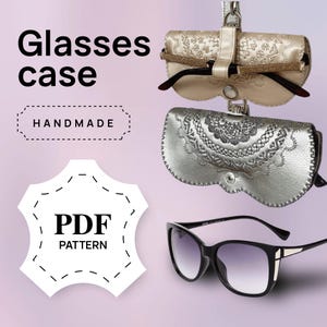 May include: The image showcases two handmade glasses cases, one gold and one silver, with intricate embossed designs. The cases are displayed with a pair of sunglasses. Text on the image reads "Glasses case", "Handmade", and "PDF Pattern".
