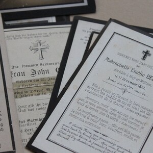 May include: A black and white mourning card with a cross at the top and the text "SOUVENEZ VOUS DANS VOS PRIERES BE Mademoiselle Em&eacute;lie BERNIER, d&eacute;c&eacute;d&eacute;e &agrave; May en Multieu, LE 17 D&Eacute;CEMBRE 1877, Dans sa 40&egrave;me ann&eacute;e".