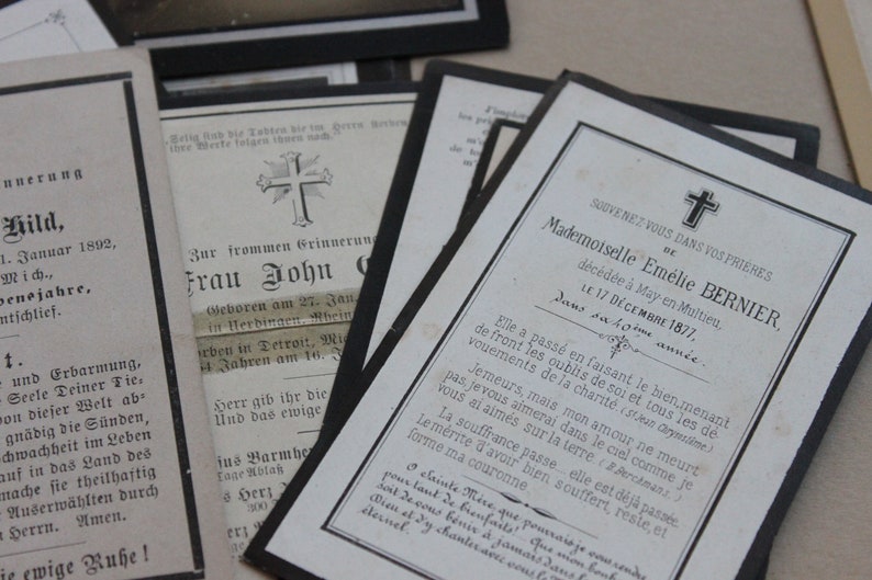 May include: A black and white mourning card with a cross at the top and the text "SOUVENEZ VOUS DANS VOS PRIERES BE Mademoiselle Em&eacute;lie BERNIER, d&eacute;c&eacute;d&eacute;e &agrave; May en Multieu, LE 17 D&Eacute;CEMBRE 1877, Dans sa 40&egrave;me ann&eacute;e".