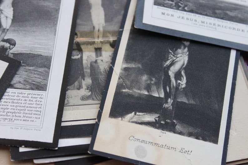 May include: A black and white photo of a religious scene with the text "Consummatum Est!" printed below the image.