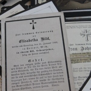 May include: A black and white mourning card with a cross at the top and the text "Zur frommen Grinnerung an Elisabetha Hild, welche am Sonntag, den 31. Januar 1892, in Detroit, Mich., in ihrem 62. Lebensjahre, felig im Herrn entschlief."  The card also includes a prayer.