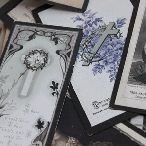 May include: A collection of vintage religious cards with black borders and floral designs. The cards feature crosses, thorns, and religious text in French. The text reads "Que la tres haute et tres aimable vous louee et glorifiee a jamais en tout"