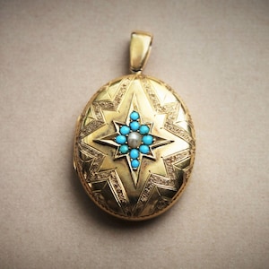 May include: A gold oval locket with a starburst design. The starburst is made of turquoise stones and a single pearl in the centre.