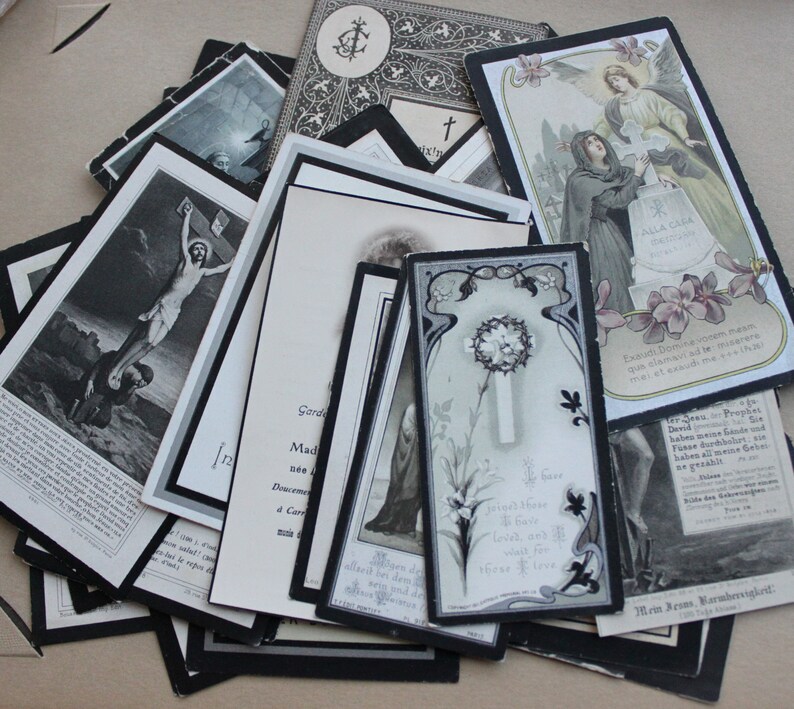 May include: A collection of vintage black and white religious cards with ornate borders and religious imagery. The cards feature images of Jesus on the cross, a praying woman, and a wreath of thorns. The text on the cards is in German.