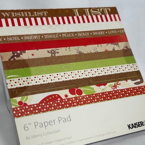 May include: A 6-inch paper pad with a Christmas theme. The pad includes 24 sheets of 160gsm designed paper, 3 glitter papers, 1 spot varnish paper, 2 flocking papers, and 4 die cuts. The paper pad is part of the "Be Merry Collection".