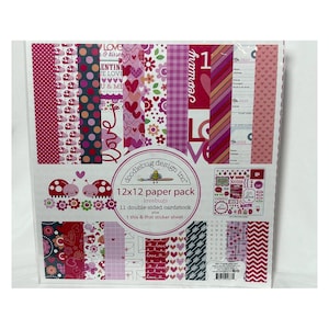 May include: A Doodlebug Design Inc. 12x12 paper pack titled Lovebugs, containing 11 double-sided cardstock sheets and one sticker sheet. The packaging displays various patterns including ladybugs, hearts, flowers, stripes, and text in pink, red, and white.