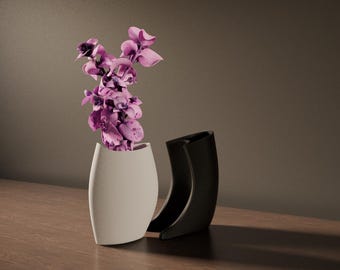 May include: A white vase with a curved design holds vibrant purple orchids. Beside it, a black vase with a similar shape stands on a wooden surface. The vases are modern and decorative, suitable for home decor.