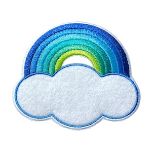 May include: A blue and green rainbow with a white fluffy cloud underneath. The rainbow is made of felt and has a stitched design.