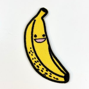 May include: Embroidered yellow banana patch with a smiling face and black outline. The banana has black speckles and a black stem. This patch is perfect for adding to clothing, bags, or other fabric items.