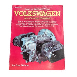 May include: A red book titled "How to Rebuild Your Volkswagen Air-Cooled Engine" by Tom Wilson. The book cover features a detailed image of an engine. The book covers models from 1961 and up.