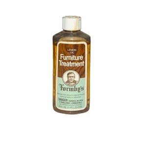 May include: A bottle of Formby's Lemon Oil Furniture Treatment. The label features the text "Furniture Treatment" and "Formby's". The bottle contains 8 fl oz (1/2 pt) or 23 liters of product. The label also includes a warning about the product.
