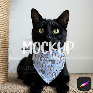 May include: A black cat wearing a light blue pet bandana with a repeating pattern of hedgehogs, flowers, and paw prints. The word "MOCKUP" is overlaid on the image. The bandana is a triangular shape and is tied around the cat's neck.