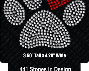 May include: A rhinestone design of a paw print with a red heart in the center. The design is 3.60 inches tall and 4.20 inches wide and uses 441 rhinestones. 360 of the rhinestones are clear and 81 are red.