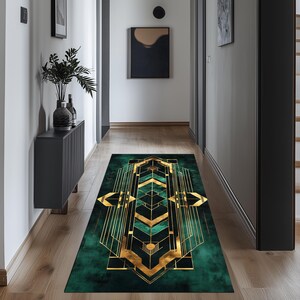 May include: A green and gold geometric patterned runner rug with a modern design. The rug is placed in a hallway with dark grey walls and wooden floors.